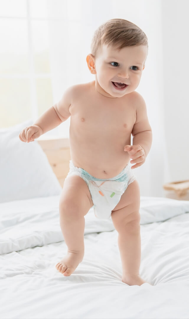 baby is wearing Non Woven Baby Diapers and smiling